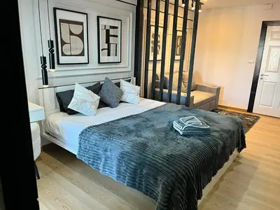 a bedroom with a bed with a book on it at The View Condo Monthly Stay Near Central Phuket 30 Day Minimum in Ban Rangeng