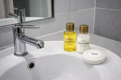 a bathroom sink with two bottles of essential oils on it at The View Condo Monthly Stay Near Central Phuket 30 Day Minimum in Ban Rangeng