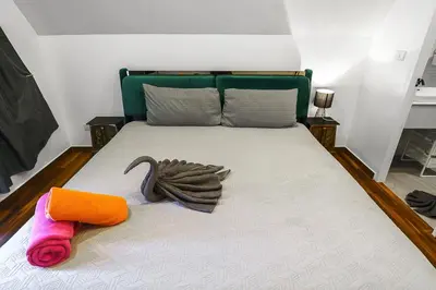 a bed with two towels on top of it at Lili Villa by G Estate Phuket in Nai Harn Beach