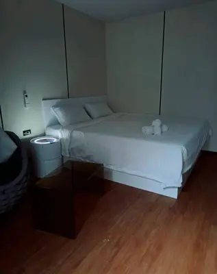 a bedroom with a bed with a teddy bear on it at NeOtel Apartments in Ban Saiyuan (1)