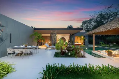 an outdoor patio with a table and chairs at Cocoon Villa 6 - Eden Escape 3 BR - Pool - Garden in Ban Sakhu