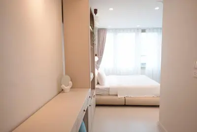 a bedroom with a bed and a window at Breeze House Patong in Patong Beach