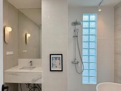 a bathroom with a shower and a sink at Breeze House Patong in Patong Beach