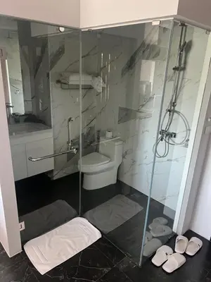 a bathroom with a toilet and a glass shower at Studio for rent in Rawai Beach