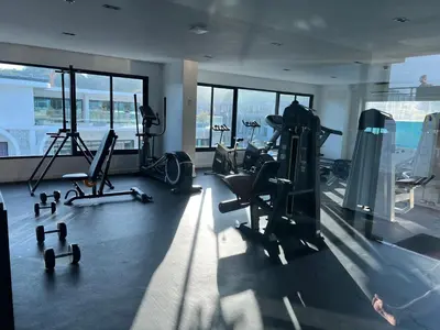 a gym with treadmills and exercise equipment in a building at Studio for rent in Rawai Beach