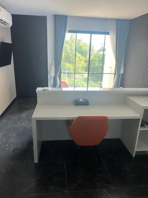 a white desk with a red chair and a window at Studio for rent in Rawai Beach