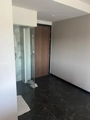 an empty room with a glass door and a wall at Studio for rent in Rawai Beach