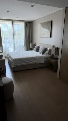 a bedroom with a large bed and a large window at 1 bedroom apartment Laguna bangtao in Laguna Phuket