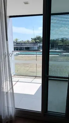 an open window with a view of a pool at 1 bedroom apartment Laguna bangtao in Laguna Phuket