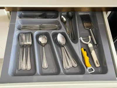 a tray with silver utensils on a table at Rawai Beach Condom in Ban Saiyuan (1)