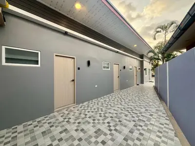 a hallway of a building with doors and tile floors at Tiny house bangtao phuket in Ban Thalat Choeng Thale