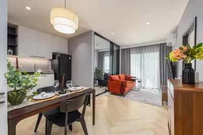 a kitchen and living room with a table and chairs at Vela 1BR Suite — The Title Legendary BangTao in Bang Tao Beach