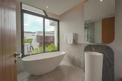 a bathroom with a large tub and a window at Zavaya Luxury Villa by 87Homes in Layan Beach