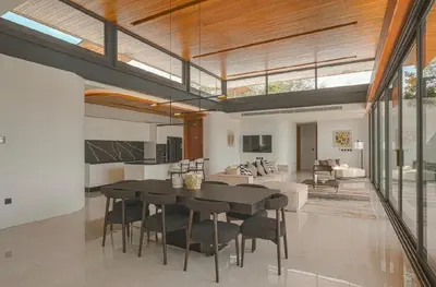 a dining room and living room with a table and chairs at Zavaya Luxury Villa by 87Homes in Layan Beach