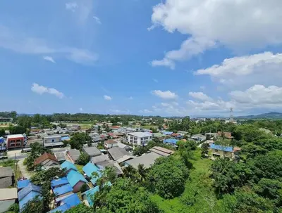 an overhead view of a town with houses and trees at VIP Great Hill Airport in Nai Yang Beach