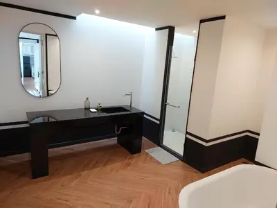 a bathroom with a black vanity and a mirror at Seaview Swimming pool Villa118-1 in Ban Ao Makham