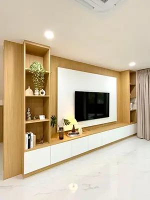 a living room with a flat screen tv on a wall at Harmony House in Ban Bang Khu