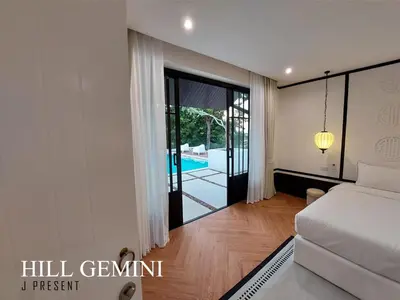 a bedroom with a bed and a view of a pool at Wild Seaview Swimming pool Villa118 in Phuket Town
