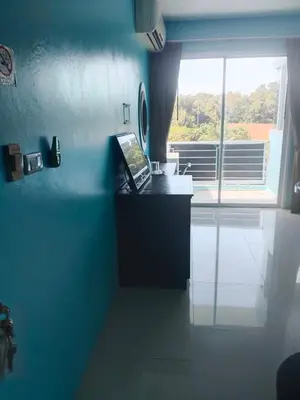 a blue kitchen with a laptop on a counter at Bedroom401 Kata Beach Phuket in Kata Beach