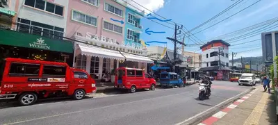 a busy city street with cars and a person on a motorcycle at Bedroom401 Kata Beach Phuket in Kata Beach