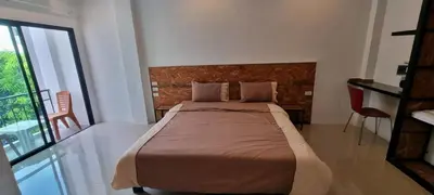a bedroom with a bed and a large window at Sawadee632,Naiharn&Rawai Beach Phuket in Phuket Town