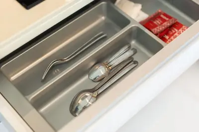 a kitchen sink with tongs in it at Serenity 2bd apartments in Cassia in Laguna Phuket