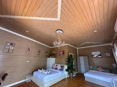 a bedroom with two beds and a wooden ceiling at Cocoloco Pool Villa Ao Nang in Ao Nang