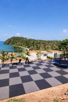 a checkered playing area with a view of the ocean at Seadome Kohyaoyai Resort & Restaurant