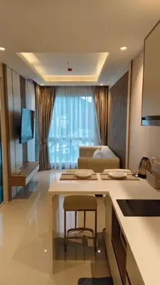 a kitchen and living room with a table and a couch at Luxury 2 Person Apartment in Heart of Phuket 2 in Ban Ket Ho