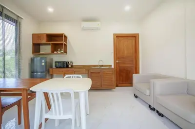 a living room with a white table and a couch at 1 bd Villa - 2 minutes to the Nai Harn beach A101, A102 in Rawai Beach