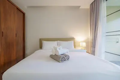 a white bed with two stuffed animals on it at 1 bd Villa - 2 minutes to the Nai Harn beach A101, A102 in Rawai Beach