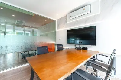 a conference room with a large wooden table and chairs at C261 Work Play & Stay City 1BR Condo Poo l& Gym in Kathu