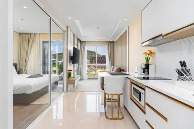 a kitchen with a counter and a bed in a room at C261 Work Play & Stay City 1BR Condo Poo l& Gym in Kathu