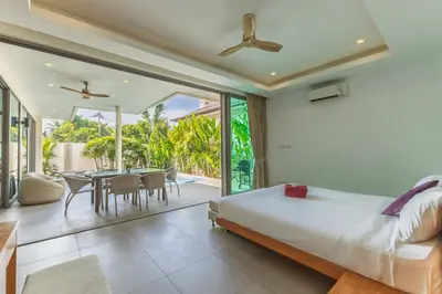 a bedroom with a bed and a dining room at 3BR Pool Villa near Rawai Beach - Villa Kamana in Rawai Beach