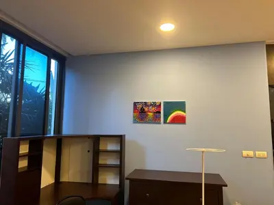 a room with a desk and a painting on the wall at Bangtao Beach Gardens 2 bedroom villa near Surin beach in Ban Lum Fuang