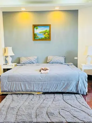 a bedroom with a large blue bed with a pair of shoes on it at Allamanda 2 lake side pad in the heart of Laguna in Laguna Phuket