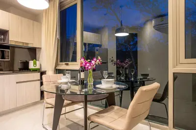 a dining room with a glass table and chairs at Oceana A32 1 BR Sea View - Kamala Beach in Kamala Beach