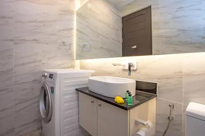 a bathroom with a sink and a washing machine at Oceana A32 1 BR Sea View - Kamala Beach in Kamala Beach