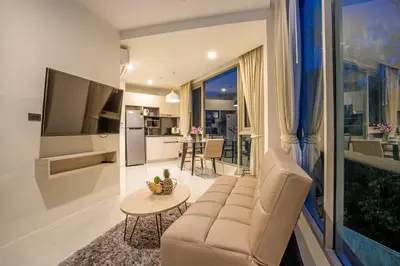 a living room with a couch and a table at Oceana A32 1 BR Sea View - Kamala Beach in Kamala Beach
