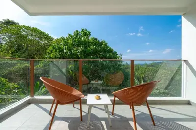 a patio with two chairs and a table on a balcony at Seaview 1BR Apt Oceana C36 near Kamala Beach in Kamala Beach