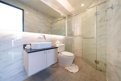 a bathroom with a toilet and a sink and a shower at Seaview 1BR Apt Oceana C36 near Kamala Beach in Kamala Beach