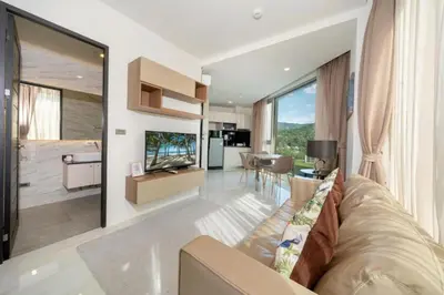 a living room with a couch and a television at Seaview 1BR Apt Oceana C36 near Kamala Beach in Kamala Beach