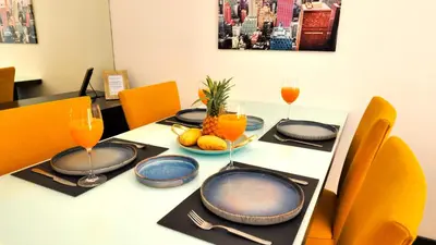 a dining room table with plates and glasses of wine at Phuket Apartment Kamala Regent Condo in Kamala Beach
