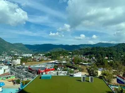 a view of a city with a green field at 1BR Panoramic Mountain View Walk to Beach by Renttini in Kamala Beach