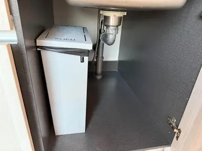 a trash can under a sink in a bathroom at 1BR Panoramic Mountain View Walk to Beach by Renttini in Kamala Beach