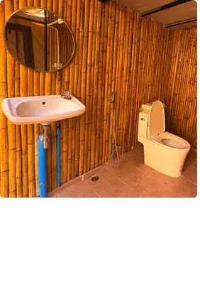 a bathroom with a sink and a toilet at Sireha Cafe Resort and Glamping in Ban Khok Chang