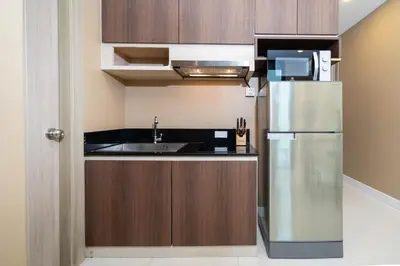 a kitchen with a stainless steel refrigerator and a sink at Beach and Party in Patong with 1BR Apt - Viva B402 in Patong Beach