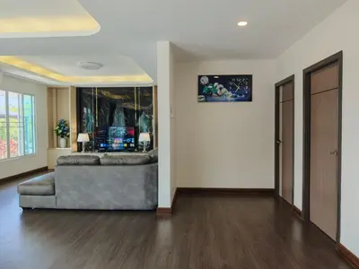 a living room with a couch and a wall at JJame Pool Villa Patong in Patong Beach