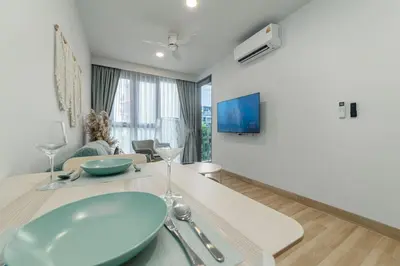 a living room with a table with a blue bowl at Premium apartment in Laguna in Thalang