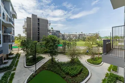 a view of a courtyard with trees and buildings at Premium apartment in Laguna in Thalang